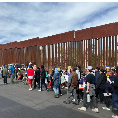 people walk along united states border wall in nogales mexico