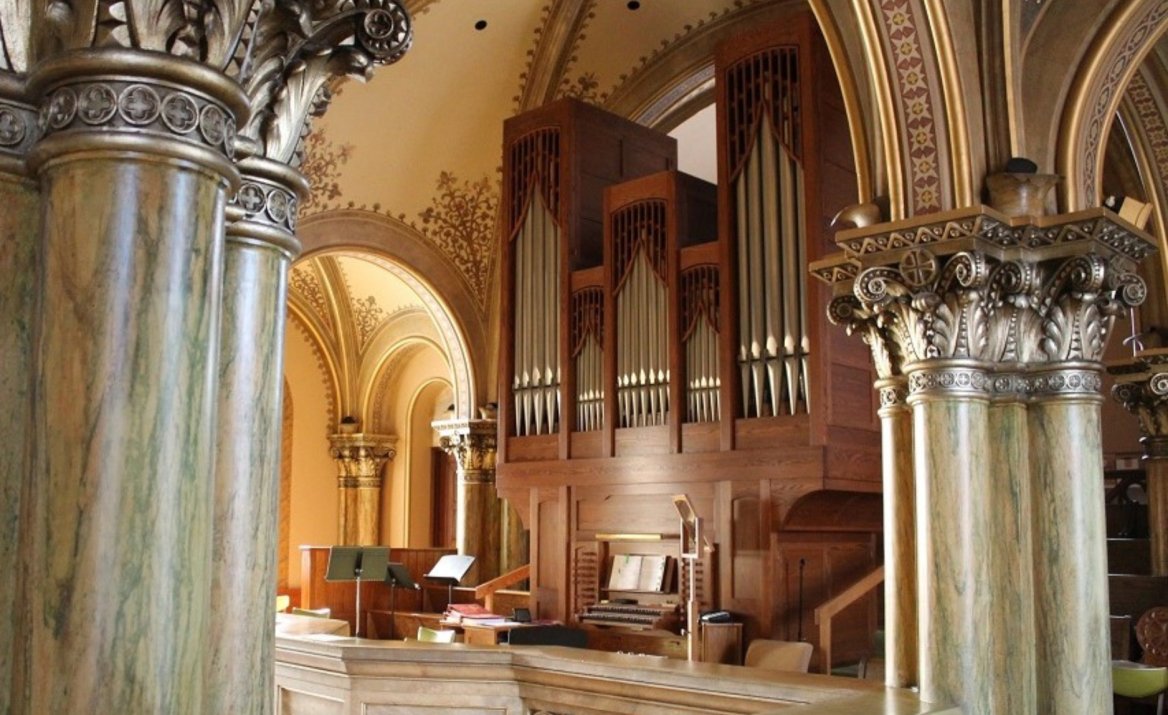 wooden pipe organ in mary of the angels chapel balcony