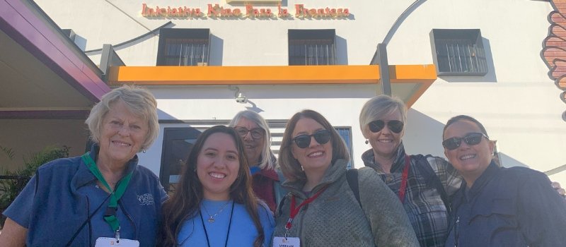 six women stand in front of Kino Border Initiative's facility in Nogales, Sonora, Mexico