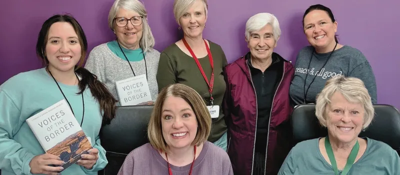 Six women pose with Sister Maria Engracia Robles Robles. The women are holding copies of her book, Voices of the Border.