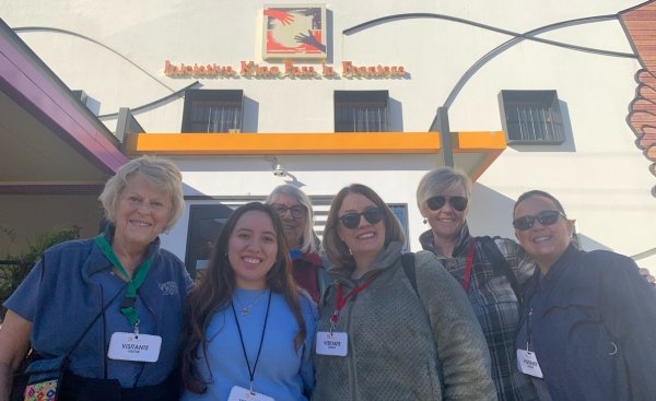 six women stand in front of Kino Border Initative in Nogales, Sonora, Mexico