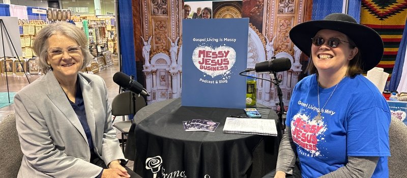 lisa hendey and sister julia walsh sit at a table ready to record a messy jesus business podcast